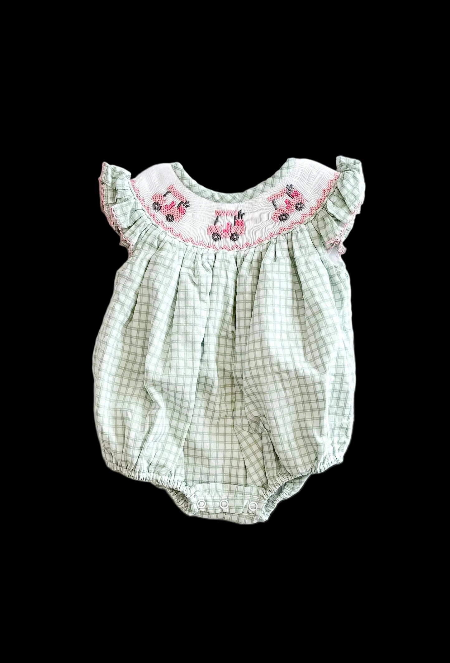 Green checkered baby romper with pink embroidery on a white background