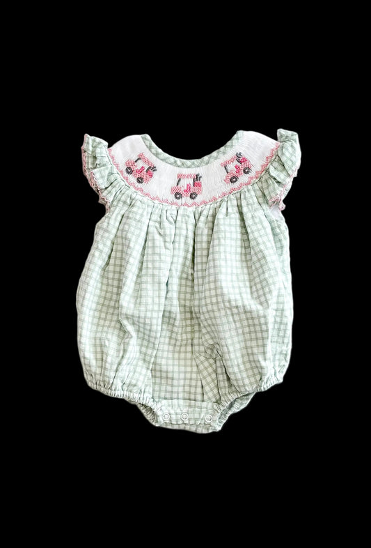 Green checkered baby romper with pink embroidery on a white background