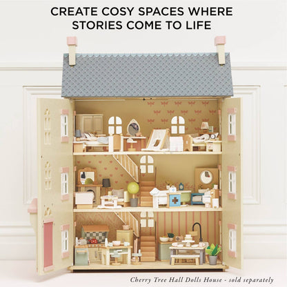A fully furnished three-floor dollhouse by Le Toy Van, Inc., with charming miniature furniture in every room. Text above: Create cosy spaces where stories come to life. Note: Complete Dolls House Furniture sold separately.
