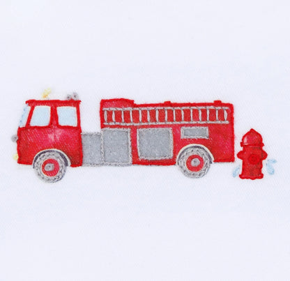 Illustration of Magnolia Baby’s "To the Rescue Footie" featuring a red fire truck with a yellow siren by a fire hydrant on white background, showcasing its high-quality construction for little adventurers.