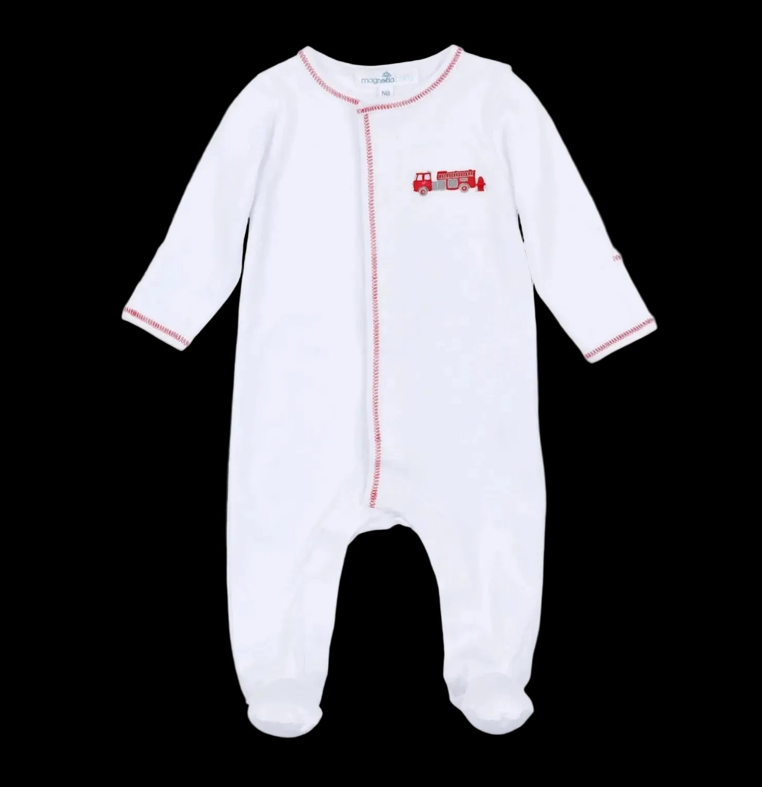 The Magnolia Baby To the Rescue Footie is a white, long-sleeve baby onesie featuring red stitching and an embroidered red fire truck on the chest, shown against a black background.