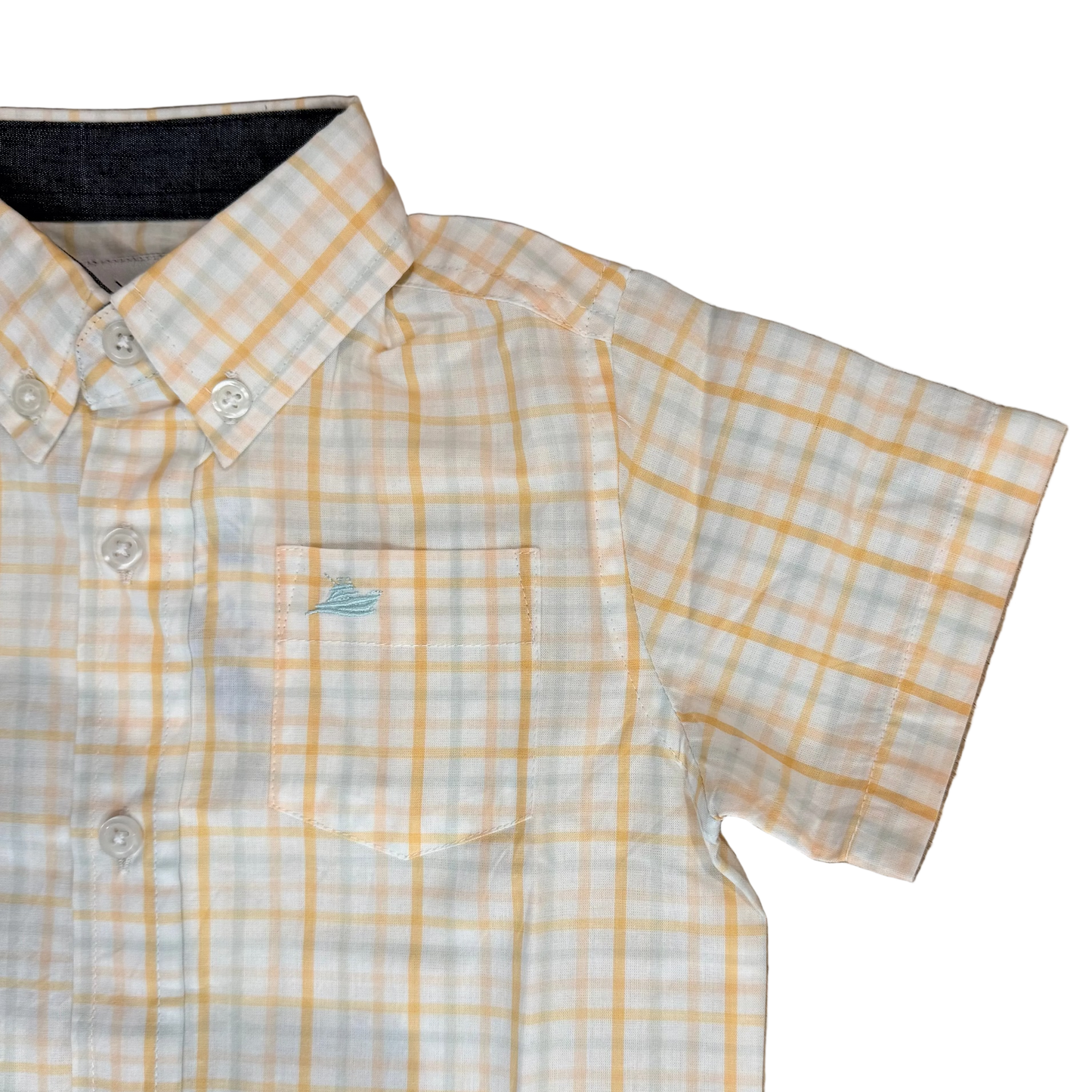 Yellow and white checkered shirt on a wooden floor