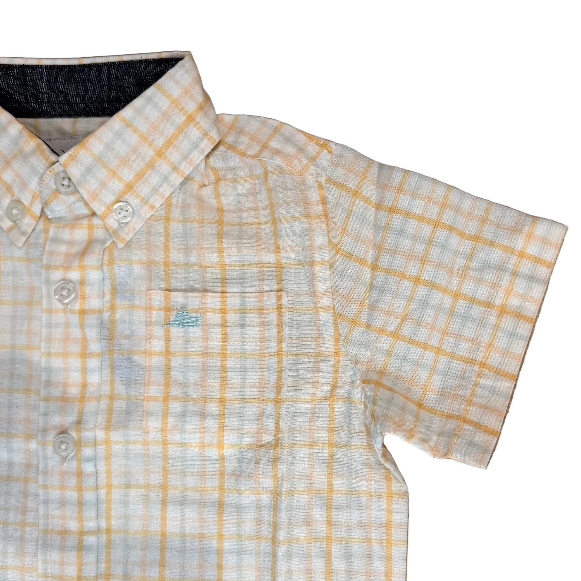 Yellow and white checkered shirt on a wooden floor