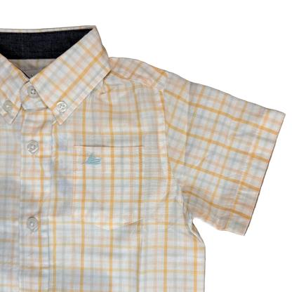 Yellow and white checkered shirt on a wooden floor