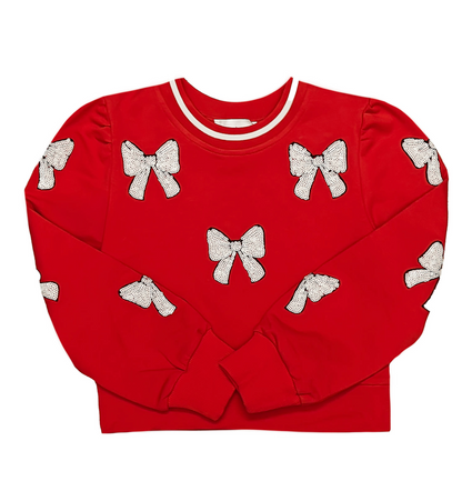 Red sweater with white bow patterns on a white background