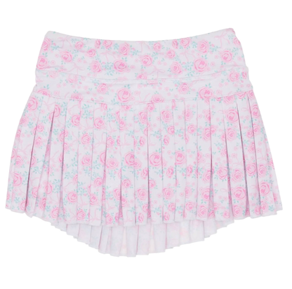 The Rosie Bows Mini Pleat Skort by Azarhia is a girls’ pleated mini skort with a pink floral pattern, delicate blue and pink roses, a slight high-low hem, and the Azarhia logo on the bottom right.