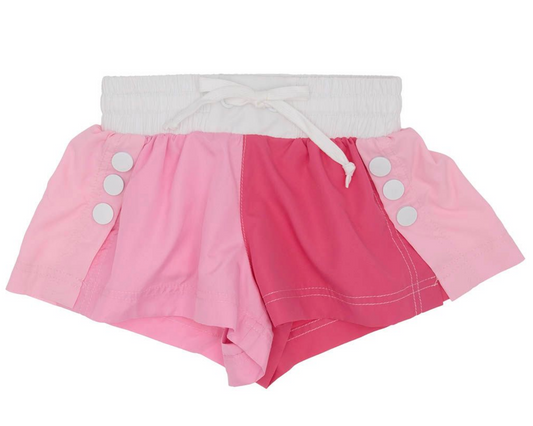 The Azarhia Pink Color Block Shorts feature light, medium, and dark pink panels, a white elastic waistband with tie waist, and four white buttons on each hip for a stylish summer look.