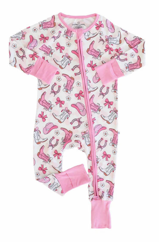 Discover the Rodeo Dreams Convertible Zip Romper | Pink by Caden Lane—a soft bamboo viscose romper featuring a pink zipper, cuffs, and Western-themed prints in pink and brown on white.