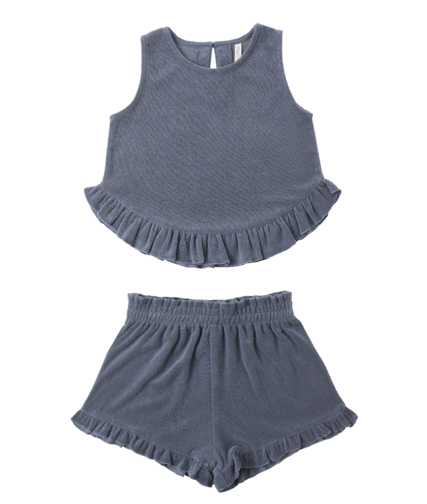 The Faye Marine Set by Rylee & Cru is a kids’ matching sleeveless gray-blue terry top and shorts, both with ruffled hems. This summer set includes a cropped top and elastic waistband shorts for easy comfort.