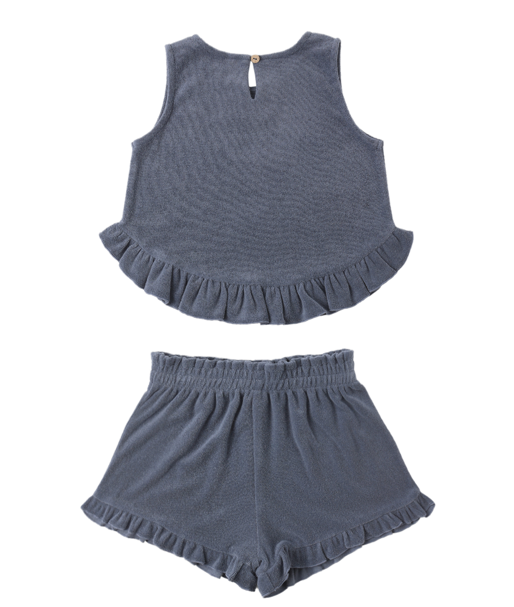 The Faye Marine Set by Rylee & Cru is a two-piece dark gray kids’ summer outfit, featuring a ruffled hem top with back button and matching shorts with an elastic waistband and ruffled leg openings.