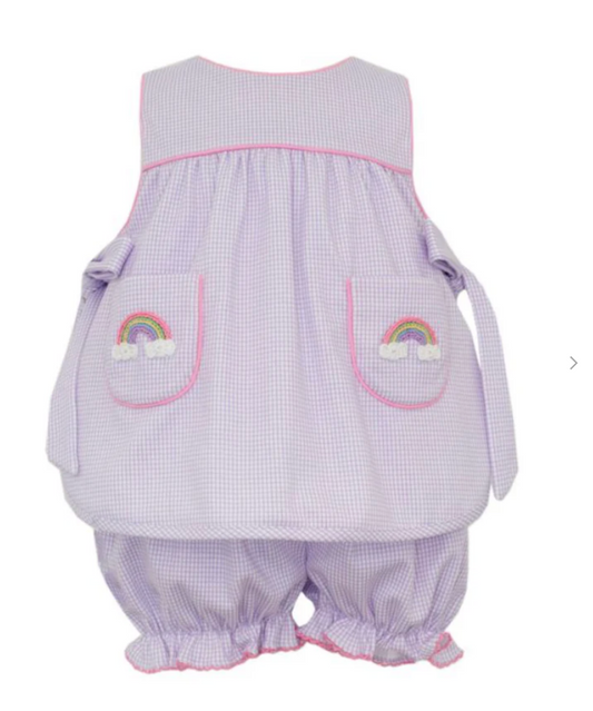 The Petie Bebe Rainbow Lilac Knit Gingham Bloomer Set features pink piping, hand-embroidered rainbow and cloud front pockets, and matching ruffled hem bloomers for a charming kids' outfit.