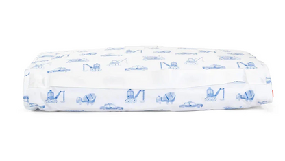 The TRVL Nap Mat by TRVL features a rectangular design with a white, machine-washable cover decorated with blue construction vehicles and cars. The elastic edge ensures a snug fit.