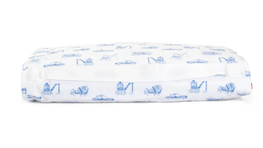 The TRVL Nap Mat by TRVL features a rectangular design with a white, machine-washable cover decorated with blue construction vehicles and cars. The elastic edge ensures a snug fit.
