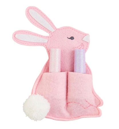 The mudpie Easter Nail Polish Sets include a pink felt bunny-shaped pouch with two pockets for pastel, glittery water-based nail polish tubes, featuring stitched facial details and a white fluffy pom-pom tail.