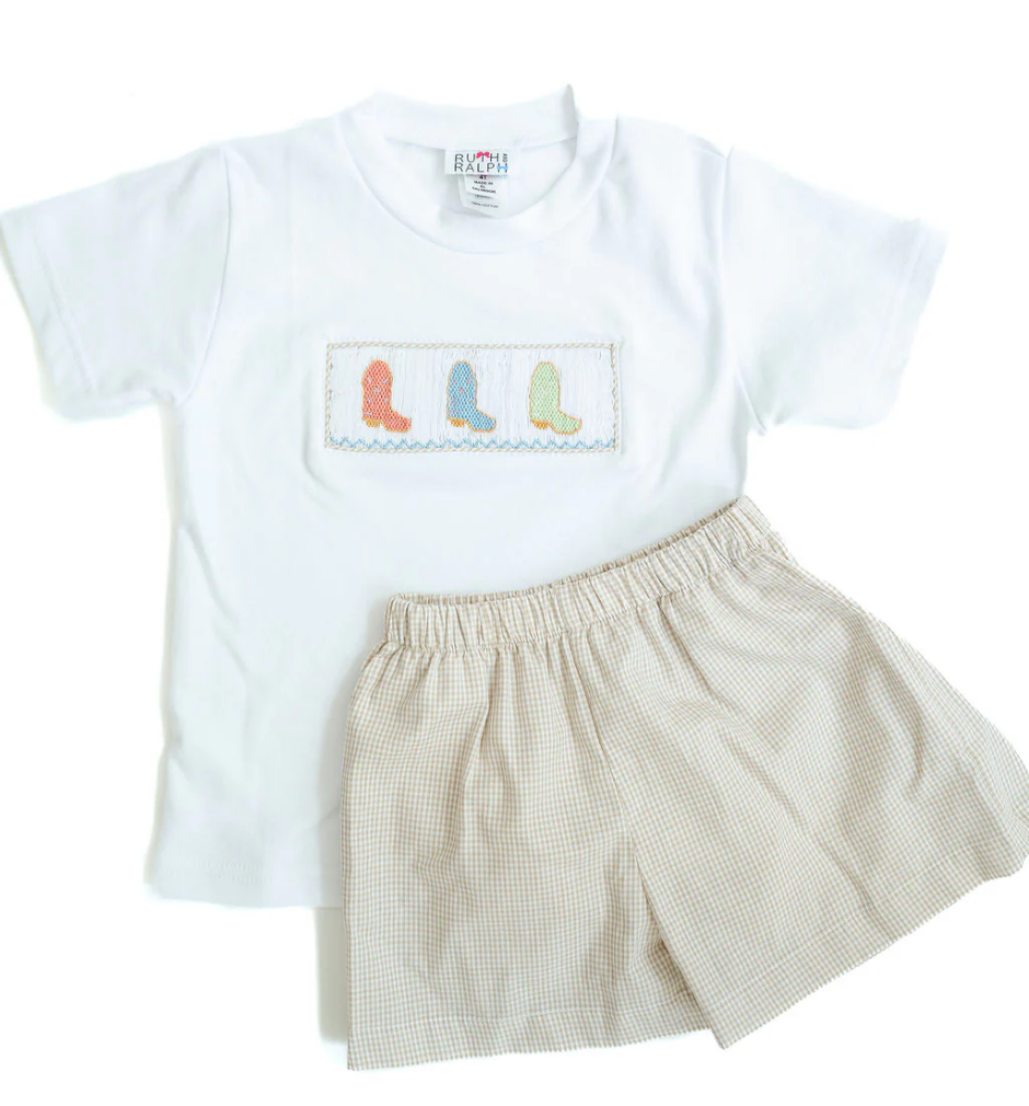 The Ruth & Ralph Cowboy Boots Smocked Beau T-Shirt/Shorts Set features a children’s short-sleeve tee with cowboy boots smocking and matching shorts, adding classic Southern charm to any wardrobe, displayed on a white background.