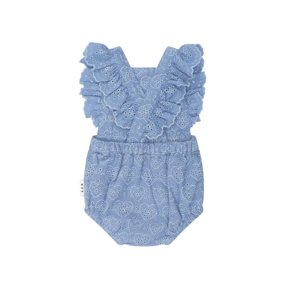 Blue lace baby romper on a light pink background