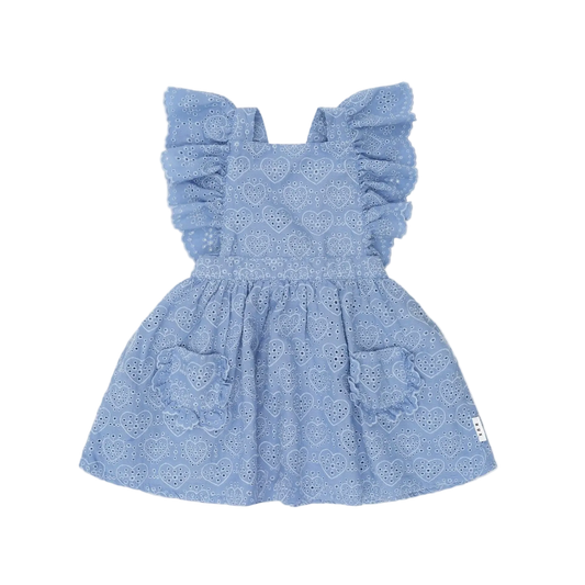 Blue dress with ruffled sleeves on a light pink background