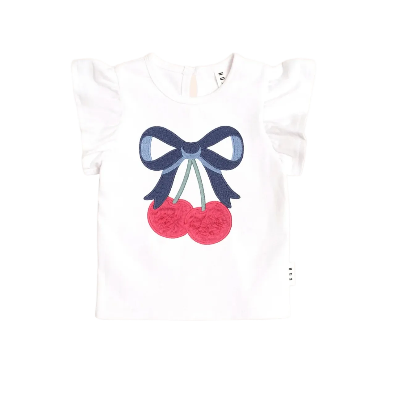White t-shirt with a blue bow and red cherries design on a light pink background