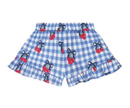 Blue checkered shorts with cherry and bow pattern on a beige background