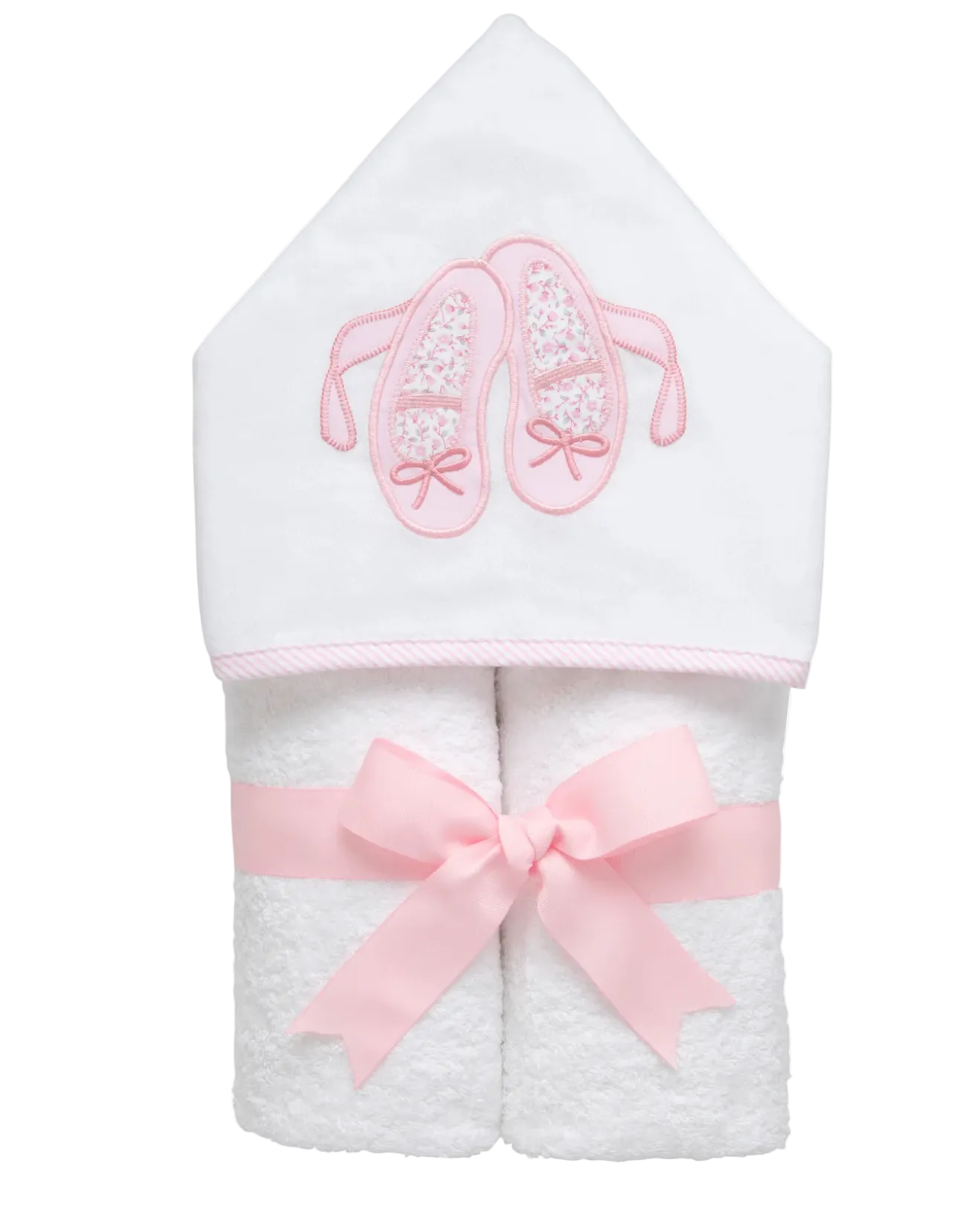 White hooded towel with pink ballet slippers and bow on a white background