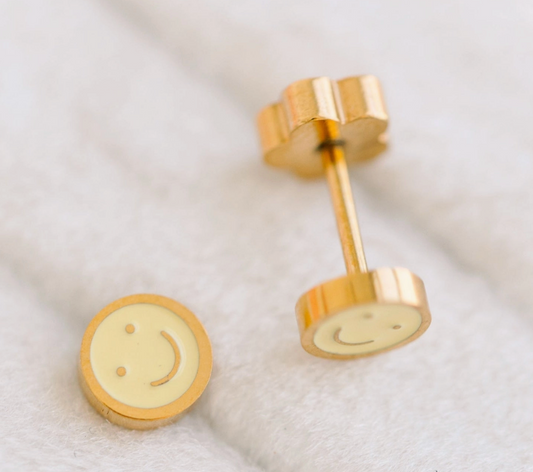 Gold smiley face earrings on a white background