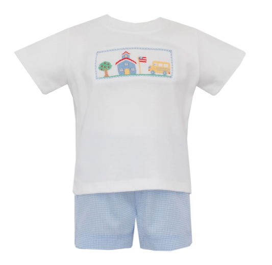 White t-shirt with a colorful hand smocking graphic and light blue gingham shorts on a white background