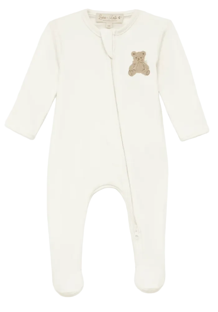White baby onesie with a teddy bear patch on a white background