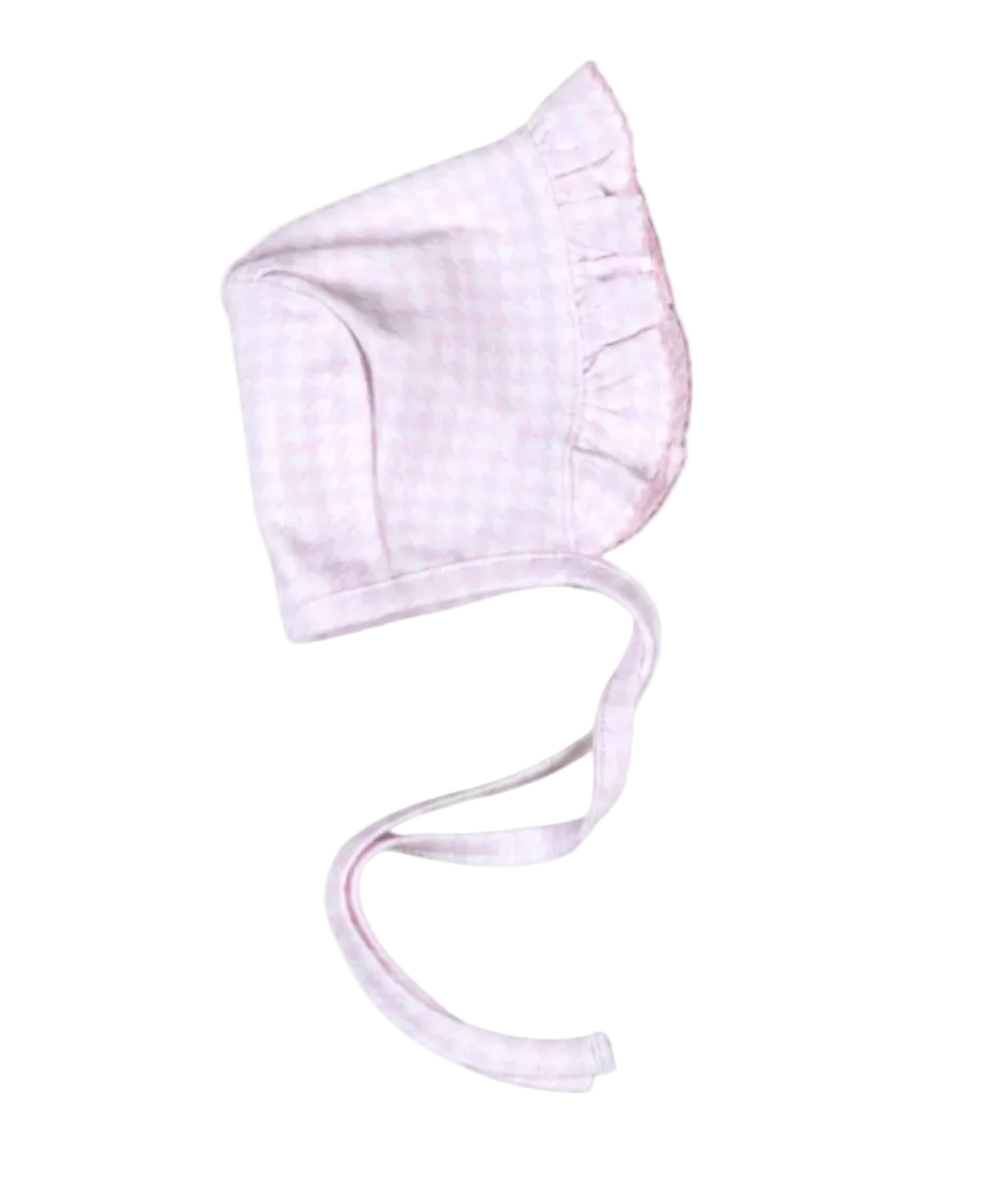 A light pink and white gingham baby bonnet with ruffled trim and adjustable ties, shown on a plain white background.