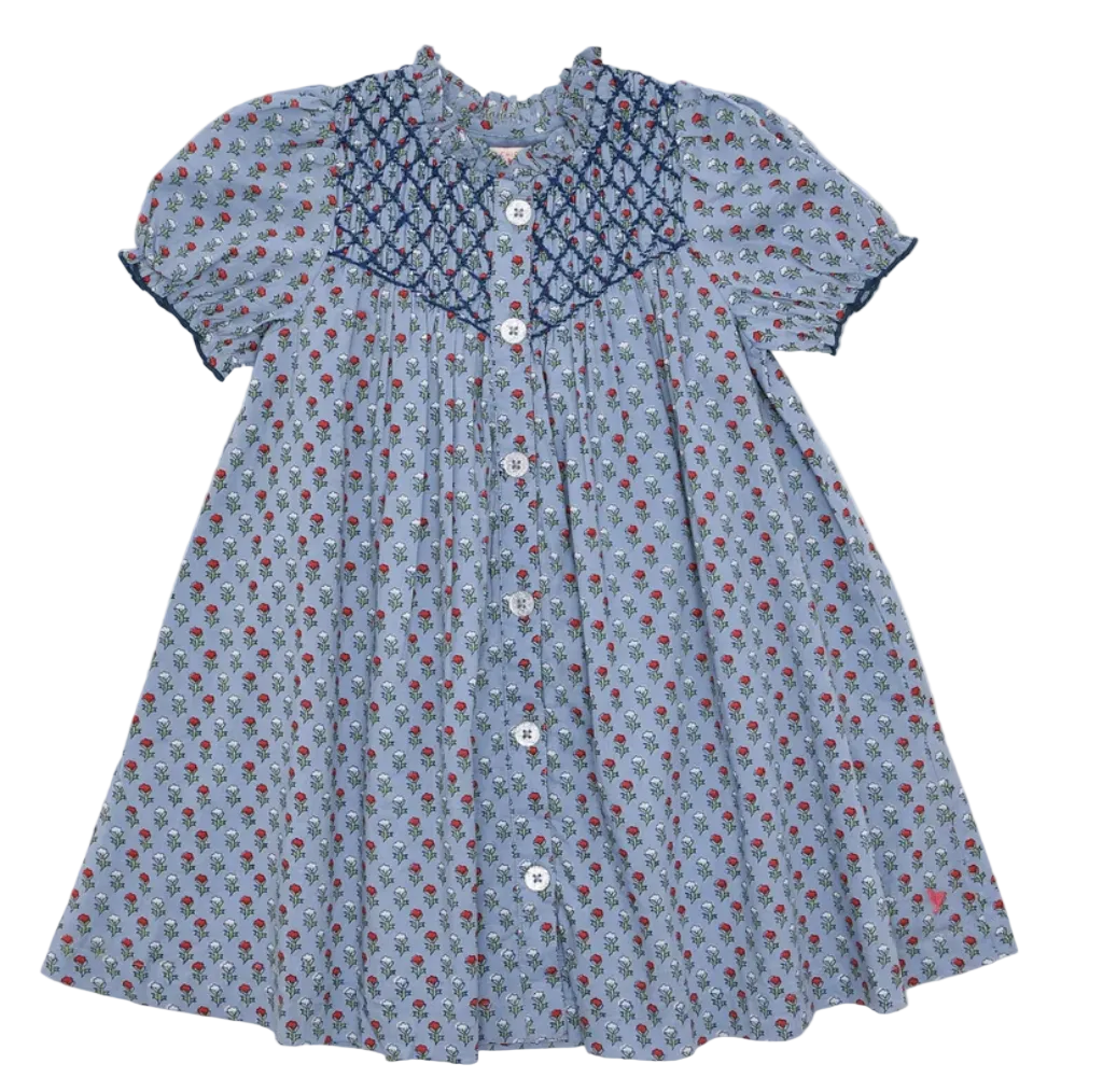 A baby girl's short-sleeve dress with a light blue floral print, a navy blue patterned yoke, and white buttons down the front, shown flat on a light gray background.