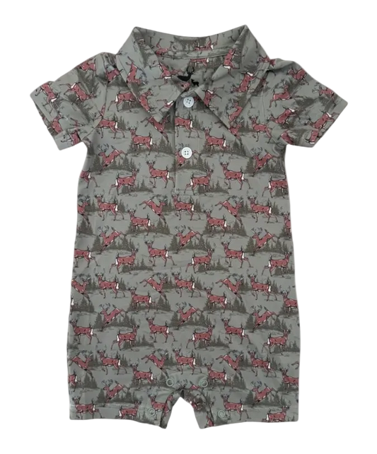 A baby short-sleeve romper in a gray-green base color with an all-over print of whitetail deer and dark pine trees. It features a camp collar and a two-button placket.