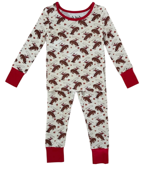 A children's long-sleeve pajama set with an allover Santa saddle print on an off-white background, featuring solid red cuffs and a red crew neck.
