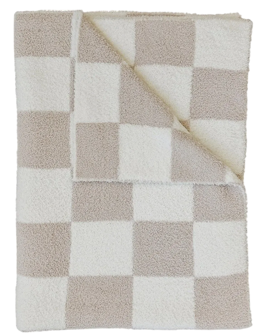A folded plush throw blanket with a beige and white checkered pattern, showing its soft sherpa lining on the reverse side.