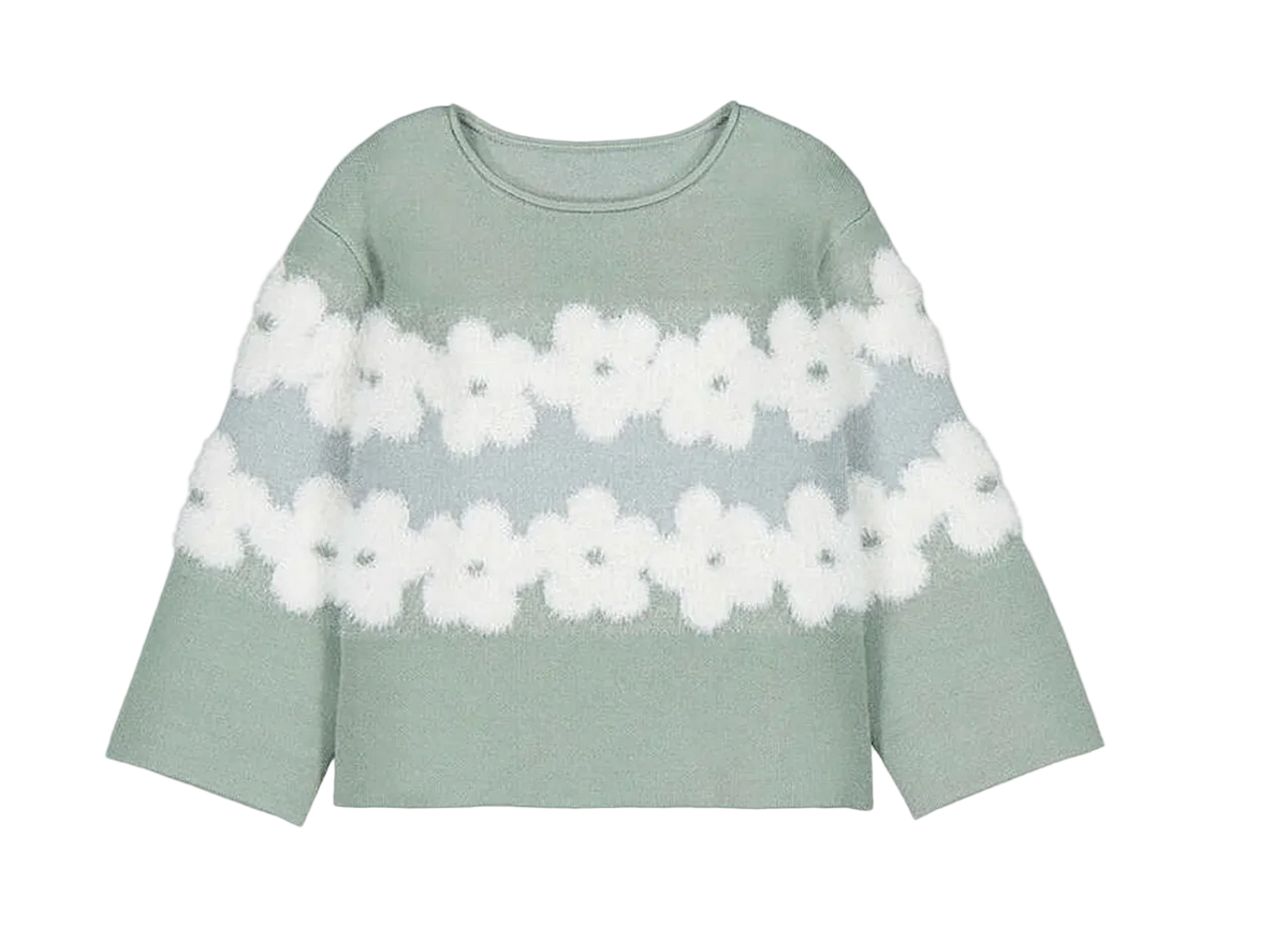 A sage green knit sweater with two horizontal rows of white fuzzy flower motifs across the chest
