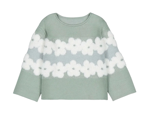 A sage green knit sweater with two horizontal rows of white fuzzy flower motifs across the chest