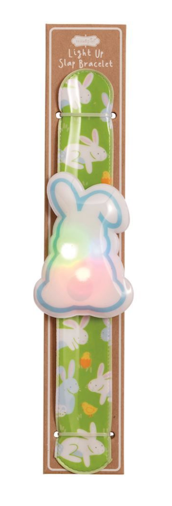 The Mud Pie Easter LED Slapbands by mudpie feature a green, light-up bracelet with white bunnies, orange carrots, and a glowing bunny centerpiece. Packaged in brown wrap labeled "Light Up Slap Bracelet"—perfect for kids’ party favors!.