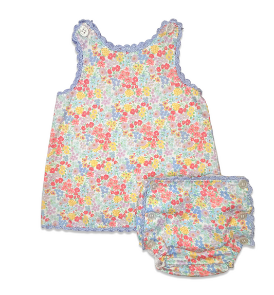 Floral baby romper with matching bloomers on a white background