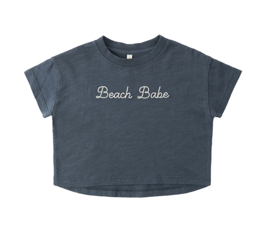Blue t-shirt with 'Beach Babe' text on a white background