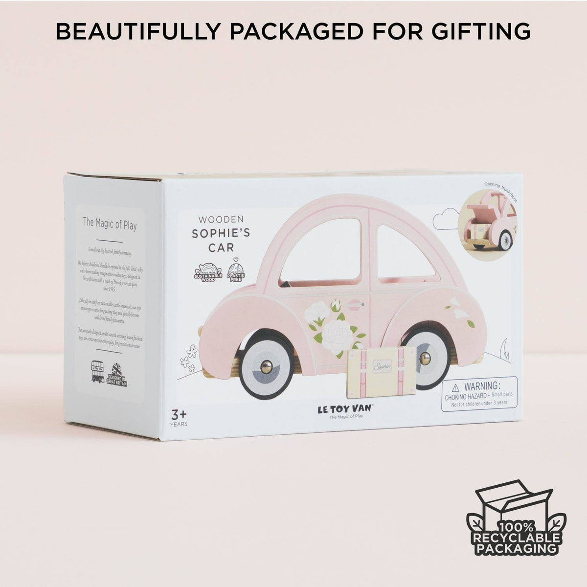A pastel pink box labeled Sophie's Dolls House Toy Car by Le Toy Van, Inc. features a retro car illustration, "Beautifully packaged for gifting" text, and a 100% recyclable packaging icon. A charming plastic-free toy for ages 3+.