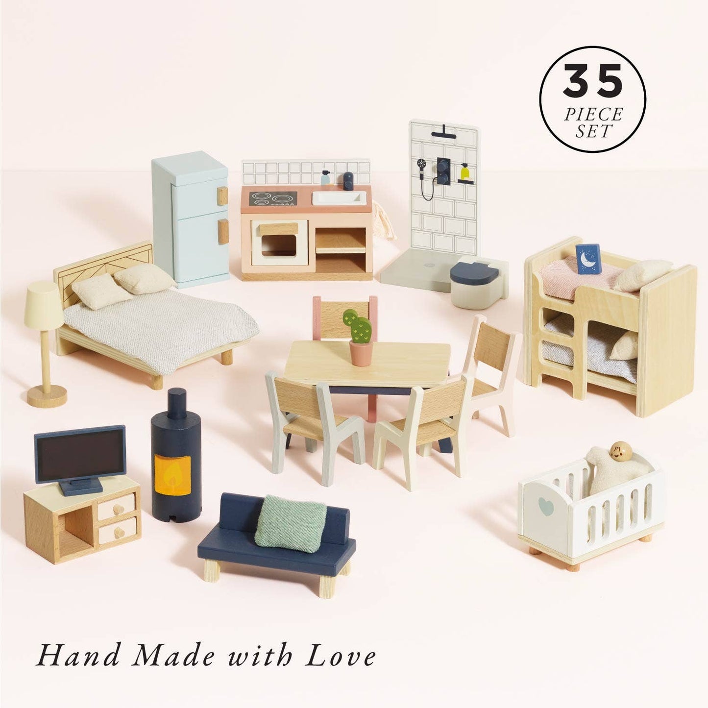 The Complete Dolls House Furniture set by Le Toy Van, Inc. includes 35 beautifully crafted mini pieces—bed, crib, fridge, stove, kitchen sink, sofa, and more—perfectly arranged against a light background.