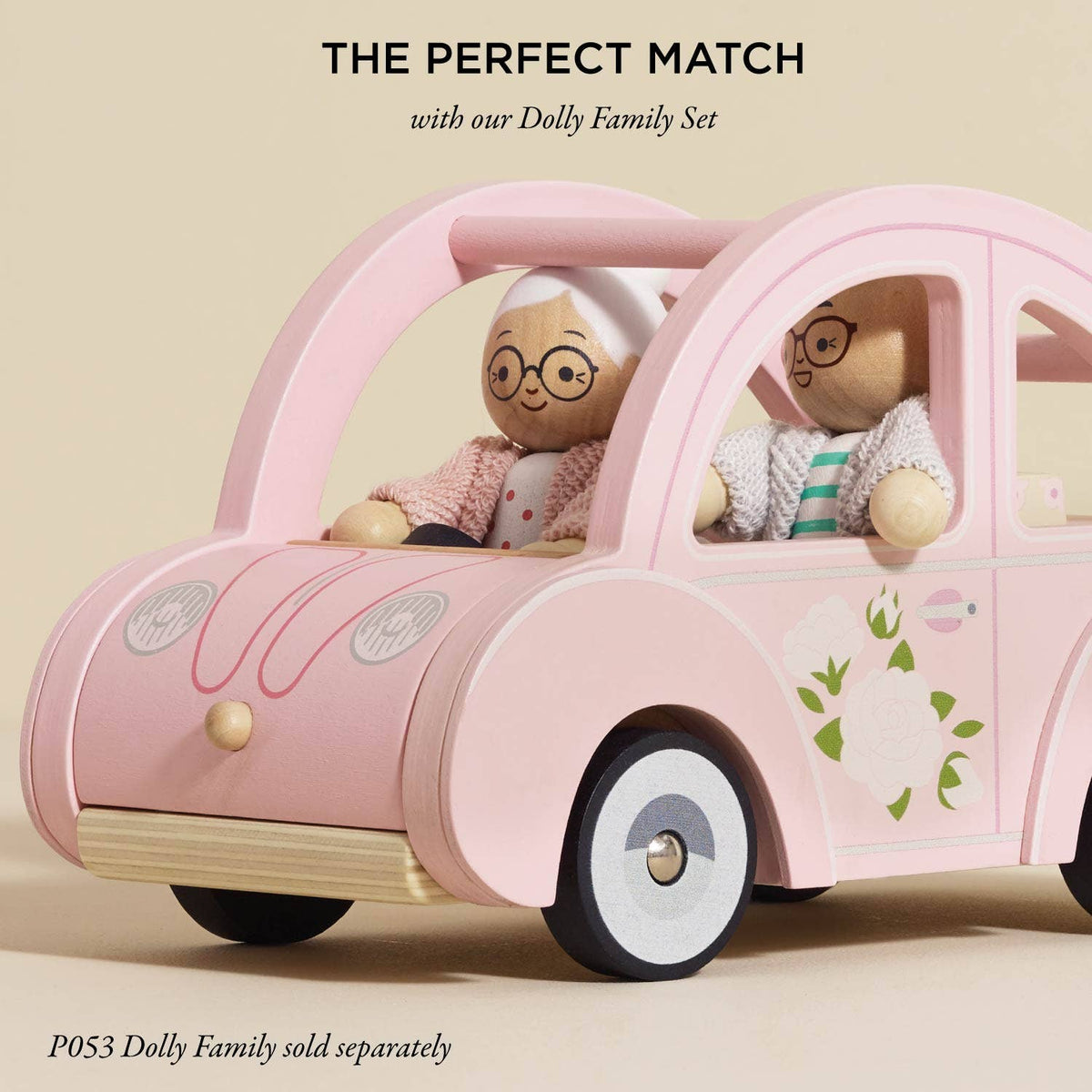 The Sophie's Dolls House Toy Car by Le Toy Van, Inc. features a pink retro wooden car with two peg dolls inside. The text reads, "The Perfect Match with our plastic-free Dolly Family Set.